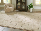 Beige rug with abstract raised line pattern, textured short pile