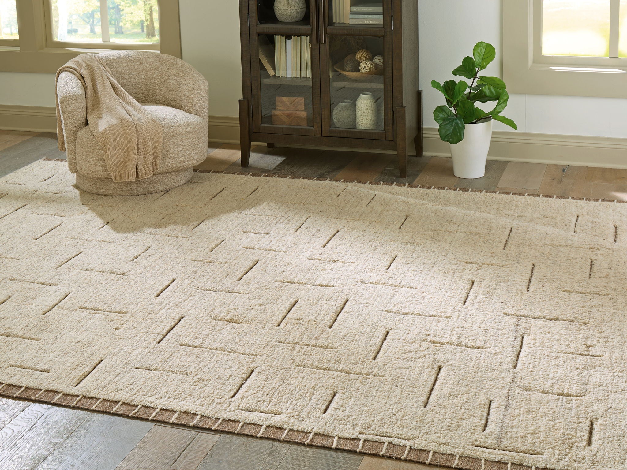 Beige rug with abstract raised line pattern, textured short pile