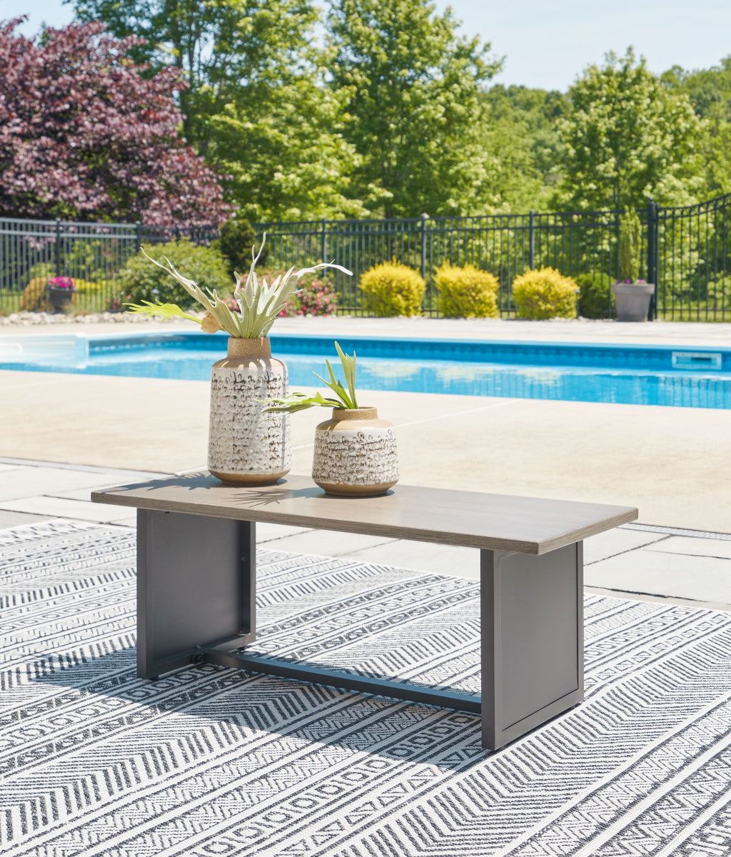 Rectangular end table with brown tabletop and dark gray frame, outdoors