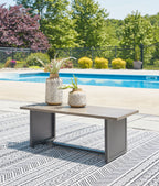 Rectangular end table with brown tabletop and dark gray frame, outdoors