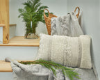Standon pillow with chunky knit braided pattern on front, light neutral, fringed edge