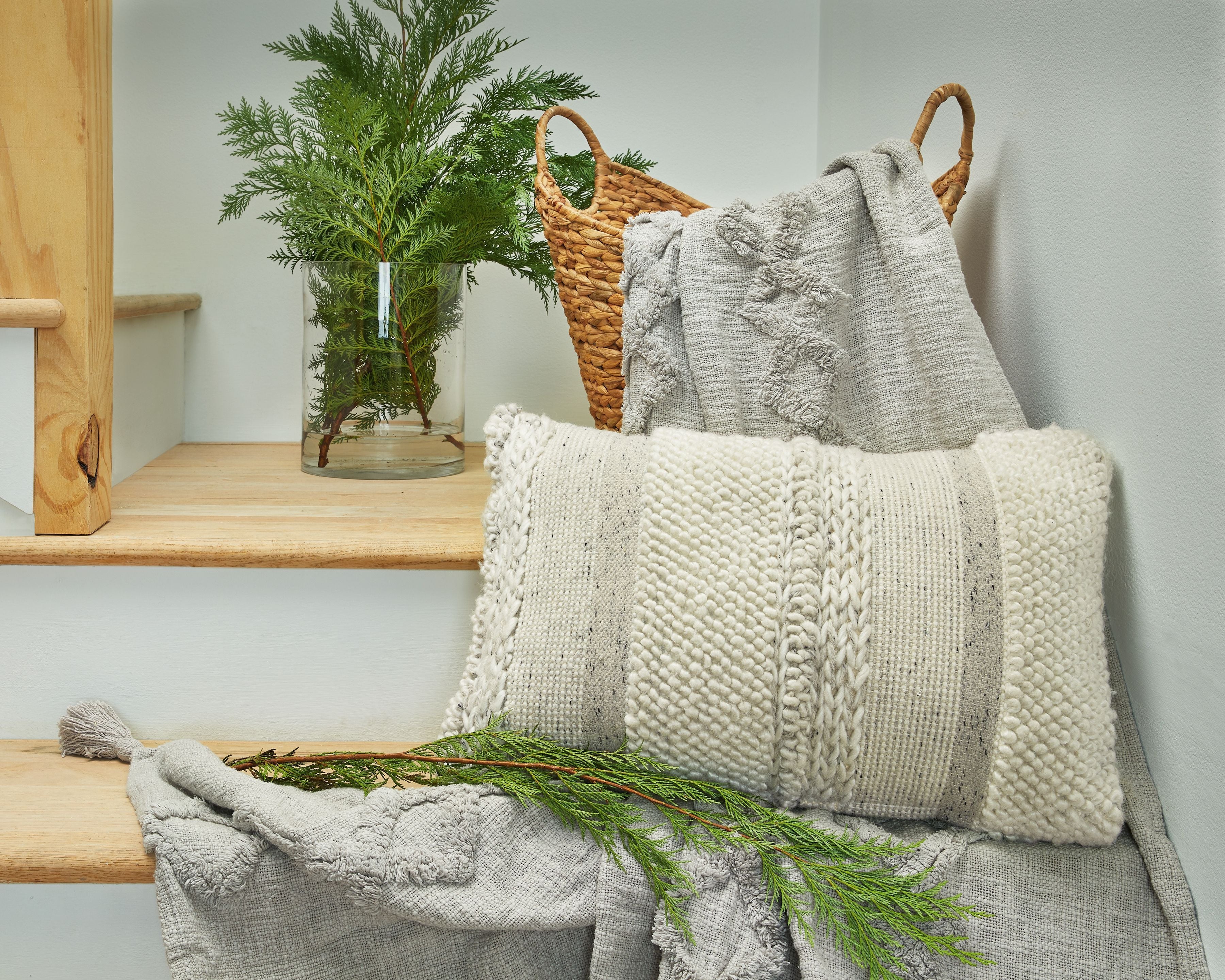 Standon pillow with chunky knit braided pattern on front, light neutral, fringed edge