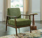 Green accent chair with upholstered seat and back, wood frame and arms