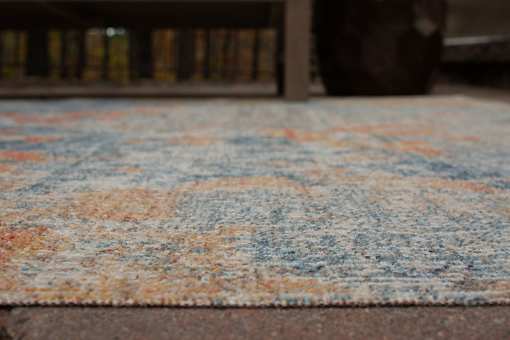 5' x 7' greige rug close-up of flat weave with speckled blue and orange pattern