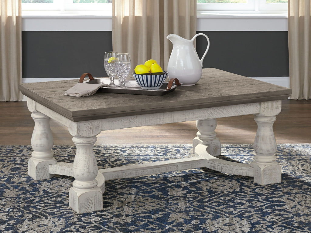 Rectangular cocktail table with gray top and white pedestal legs