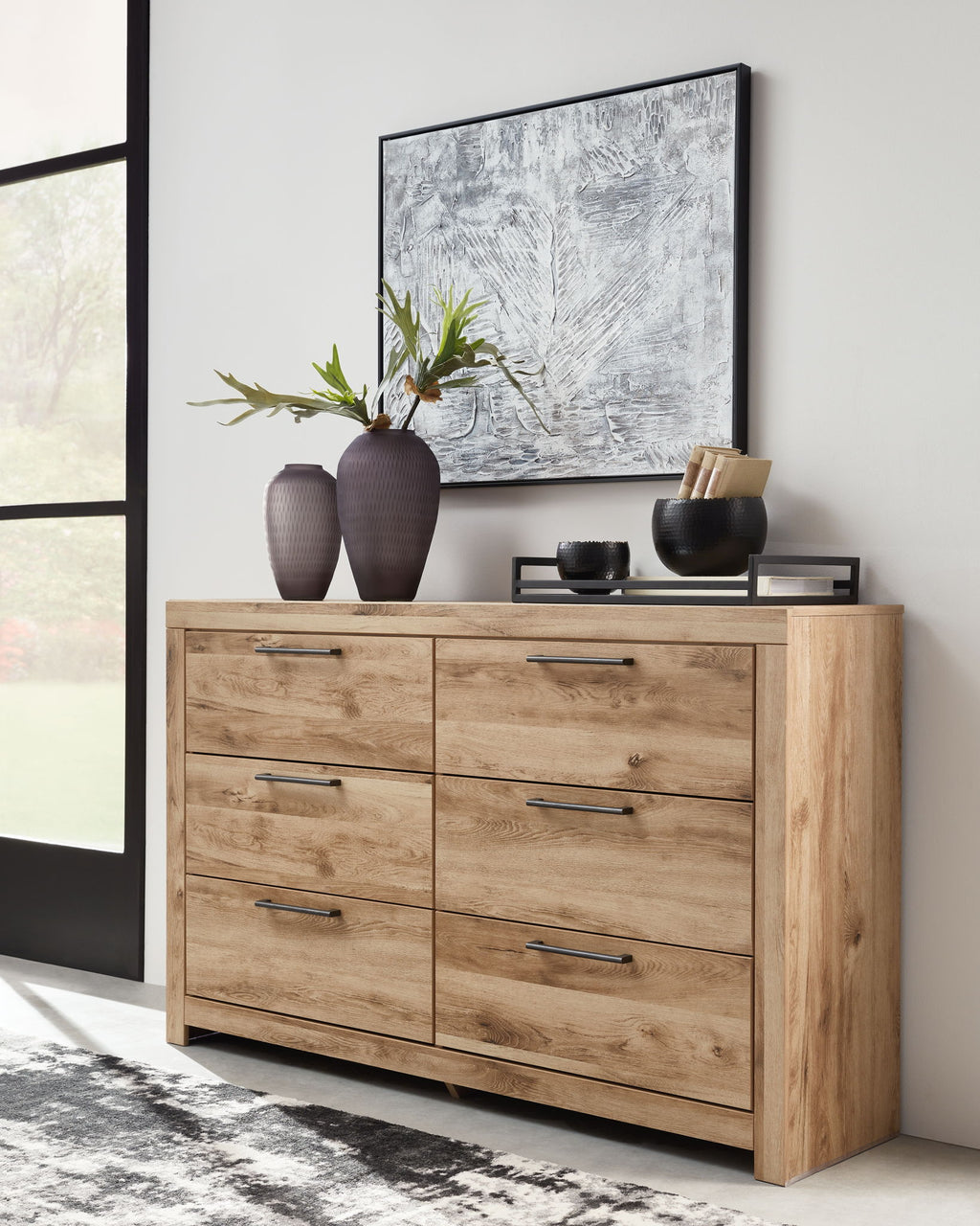 Beige wood dresser with eight drawers and silver bar handles