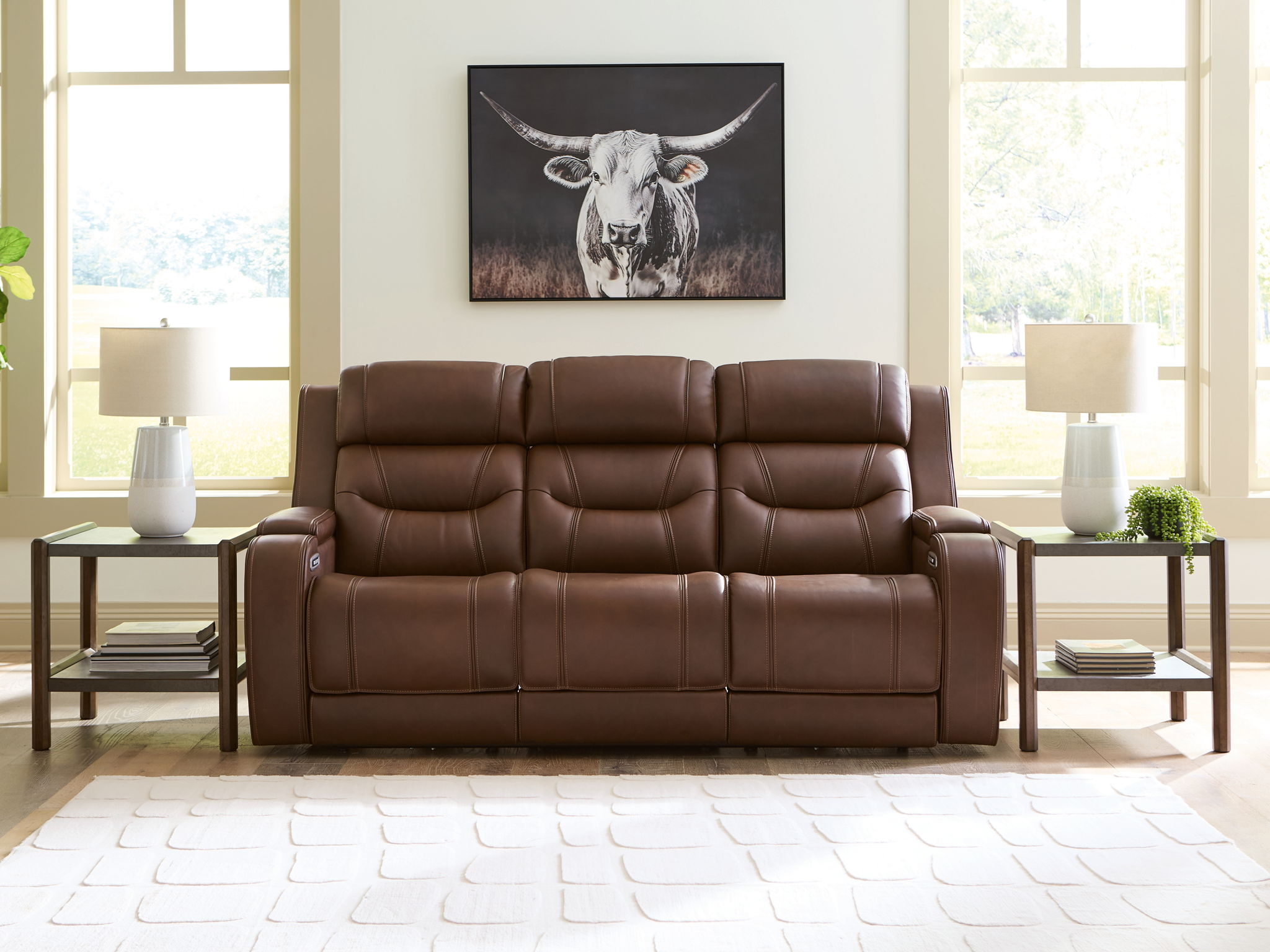 Dark brown power reclining sofa with tufted back cushions and padded armrests