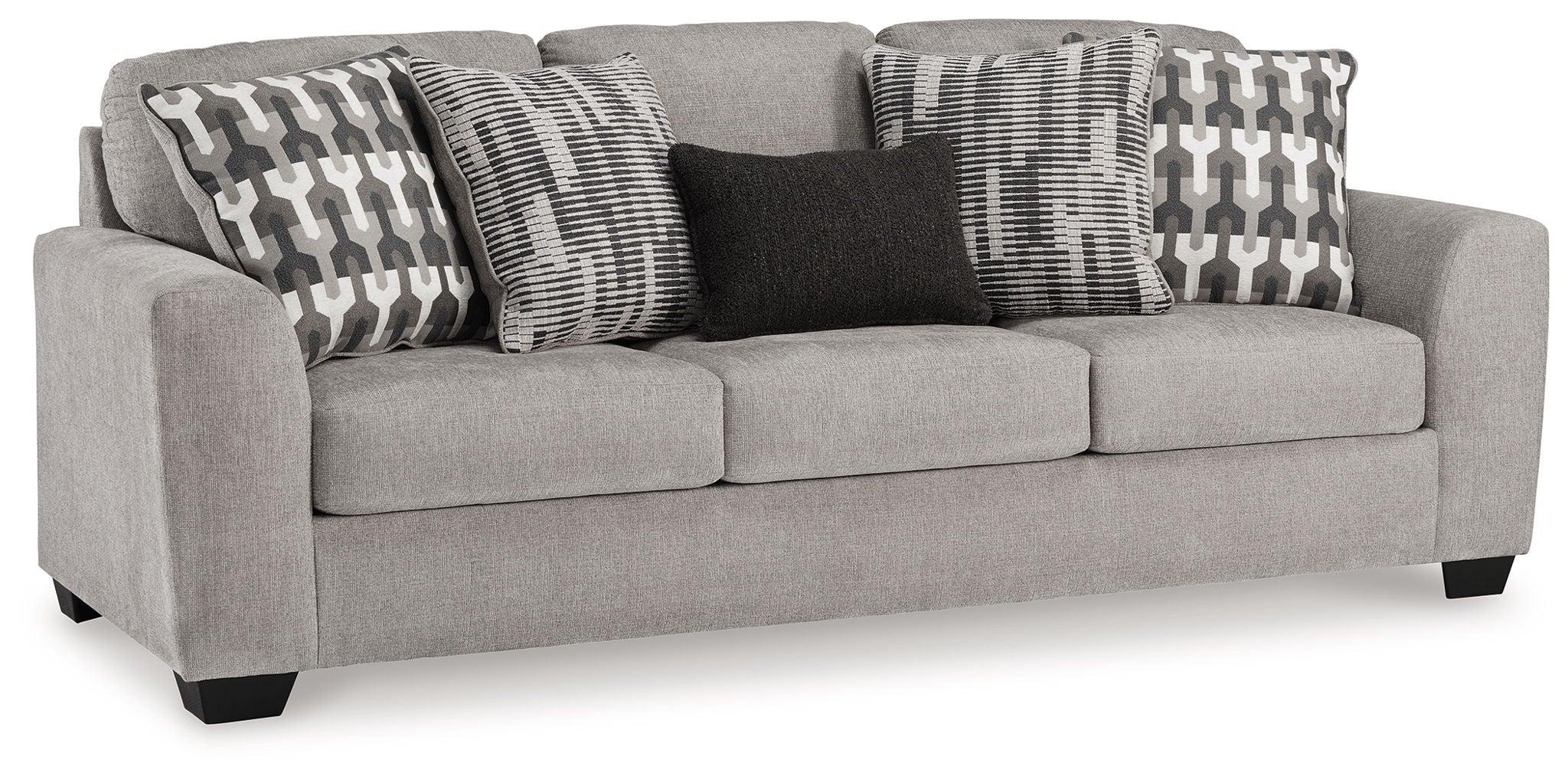 Gray upholstered loveseat with three patterned pillows and dark accent pillow