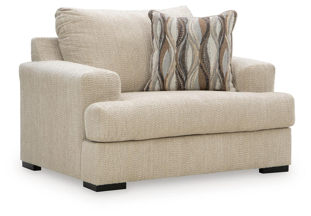 Lofwood chair and a half in beige upholstery with wide arms and patterned lumbar pillow
