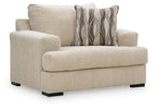 Lofwood chair and a half in beige upholstery with wide arms and patterned lumbar pillow