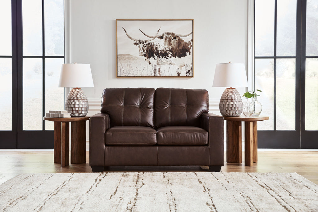 Dark brown leather-look loveseat with tufted backrest and split seat cushions