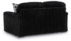 Black corduroy loveseat with tufted back and one patterned side pillow