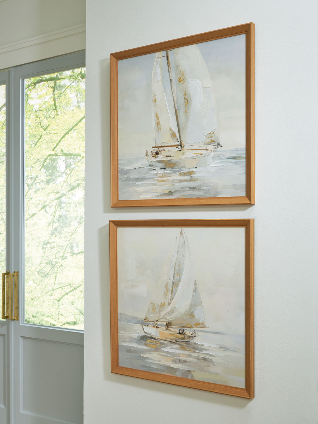 Sailboat wall art set of 2 in tan wood frames, displayed on a light wall