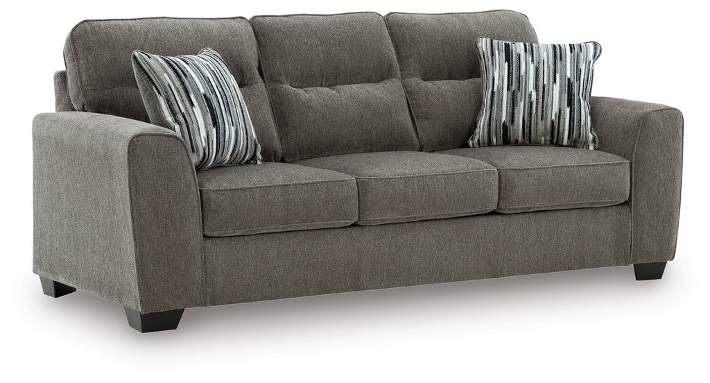 Dark gray fabric loveseat with tufted back, padded arms, and two striped throw pillows