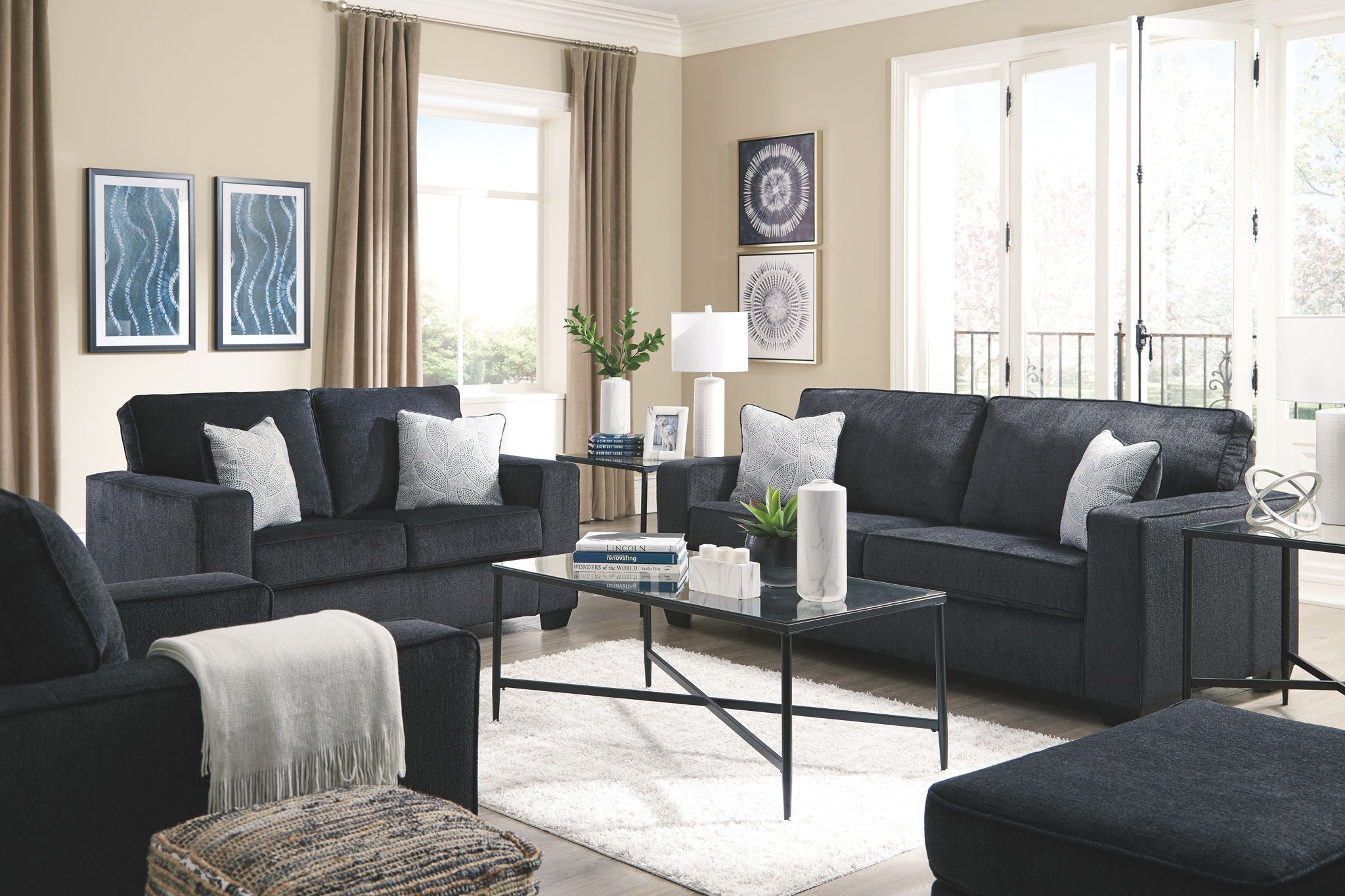 Dark gray fabric sofa and loveseat with throw pillows