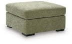 Oversized accent ottoman in green upholstered fabric with thick padded lid and dark block legs.