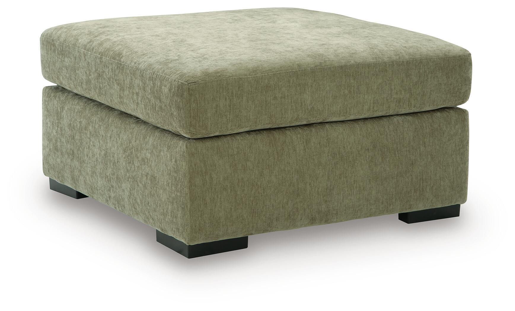 Oversized accent ottoman in green upholstered fabric with thick padded lid and dark block legs.