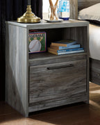Gray one-drawer nightstand with open shelf and drawer, bar handle, weathered wood finish.