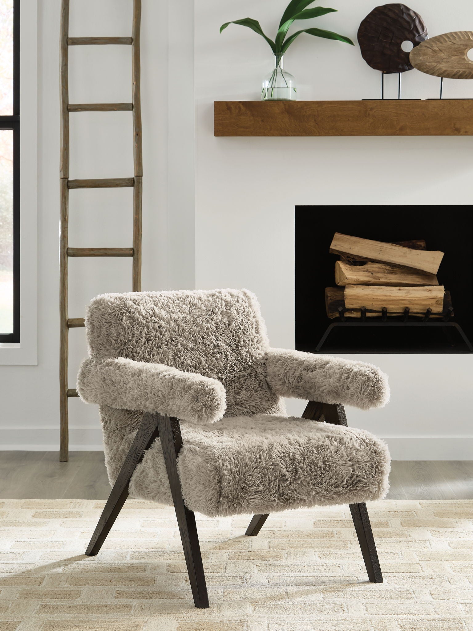 Light gray shag accent chair with rolled arms and dark wooden legs