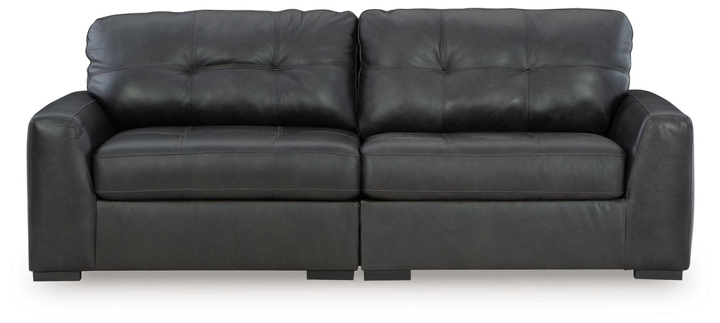 Dark upholstered sectional sofa with tufted back cushions and track arms