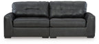 Dark upholstered sectional sofa with tufted back cushions and track arms