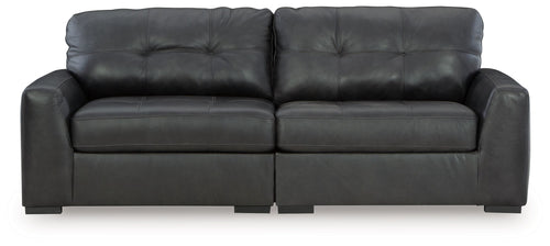 Dark upholstered sectional sofa with tufted back cushions and track arms