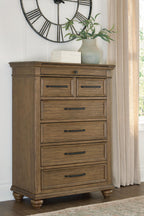 Medium brown wooden chest of drawers with seven drawers and dark bar pulls