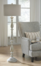 Whitewash poly floor lamp with beige fabric drum shade and round carved base