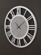 Reinport wall clock on dark wall, mirror frame, gray face, Roman numerals and black hands