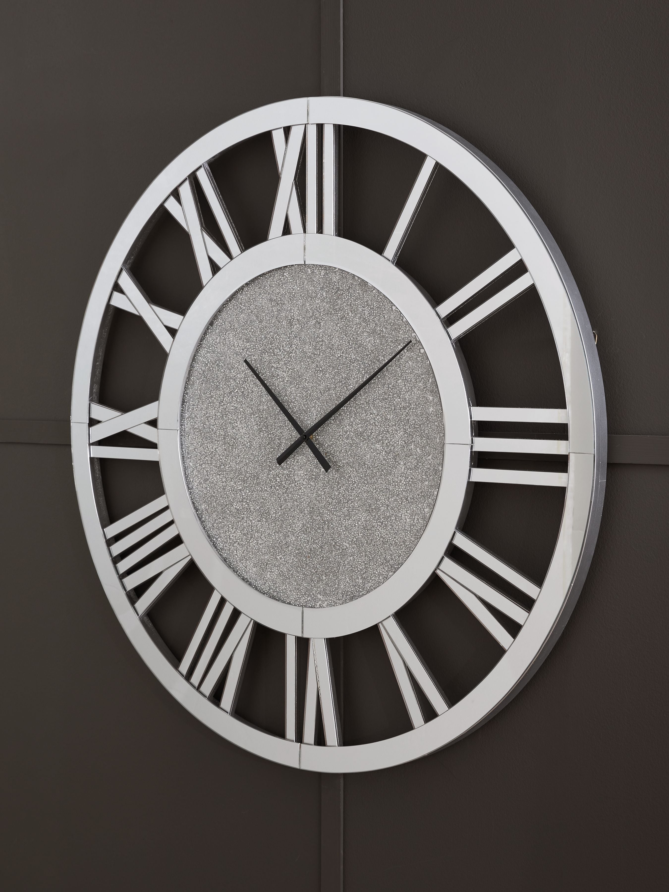 Reinport wall clock on dark wall, mirror frame, gray face, Roman numerals and black hands
