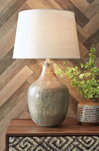 Gray glass table lamp with beige fabric shade and gold-toned base