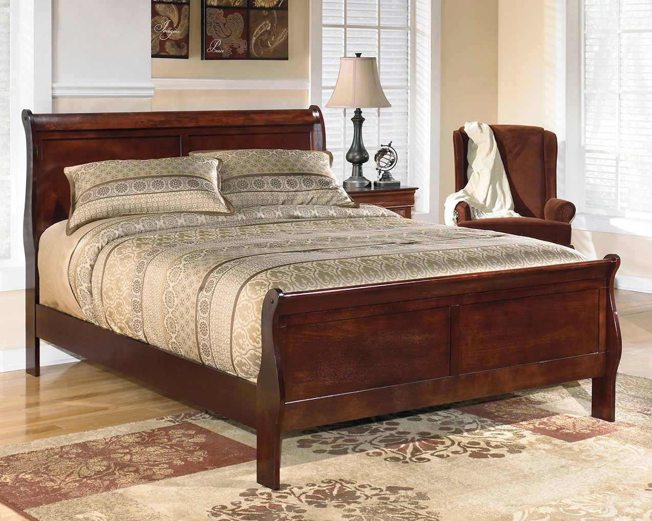 Dark brown sleigh bed with paneled headboard and footboard, patterned bedding