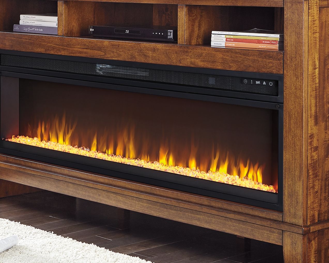 Black wide fireplace insert with visible flames, built-in style in a wooden console