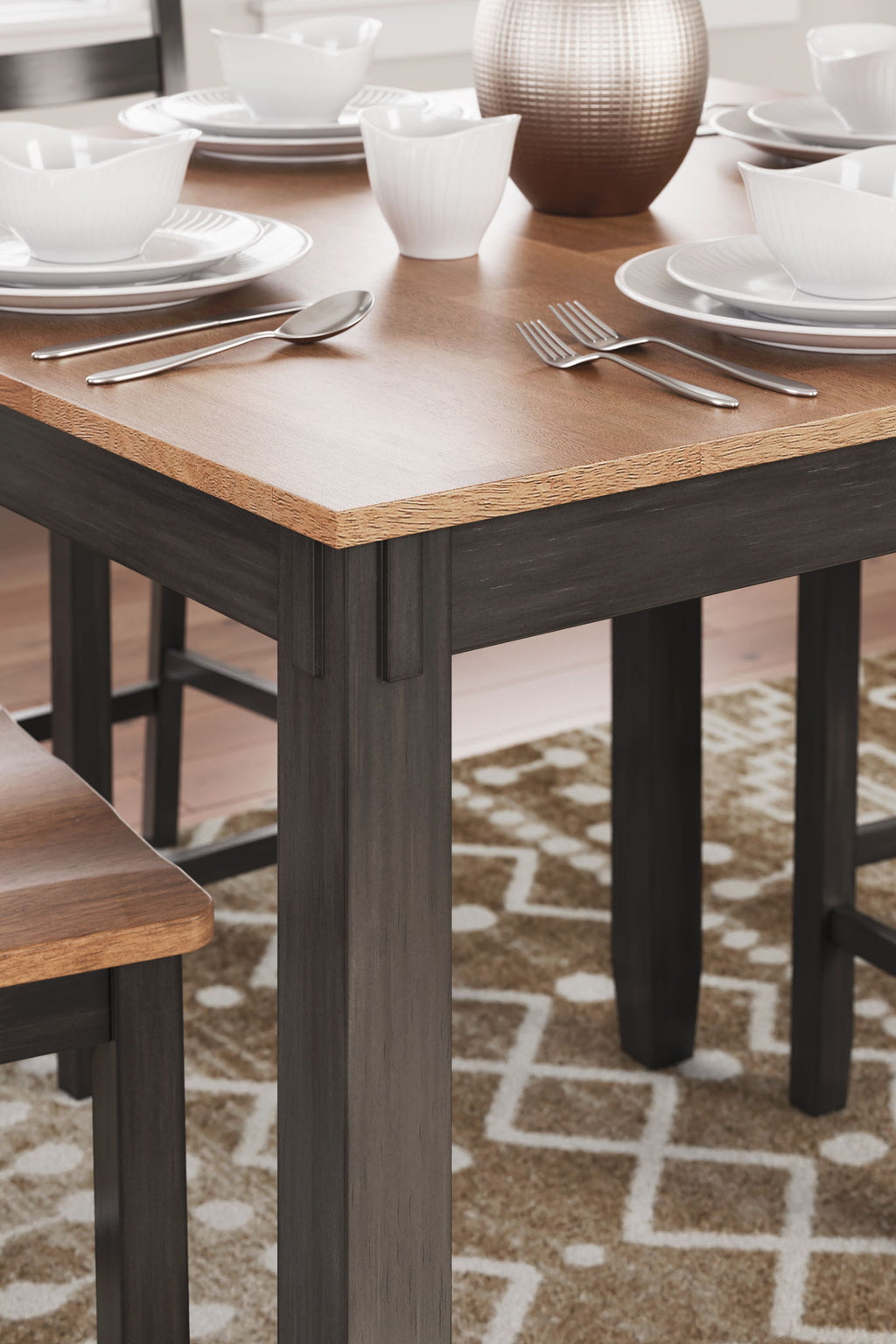 Rectangular dining table top in dark wood with chair legs and apron, close-up