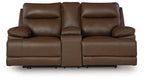 Power reclining loveseat in dark brown leather with console and padded armrests