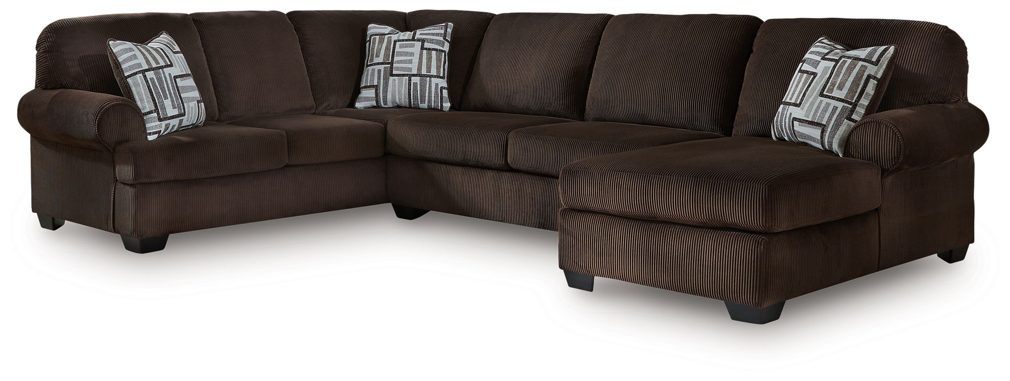 Chocolate sectional sofa with chaise and three seat back cushions, with patterned throw pillows