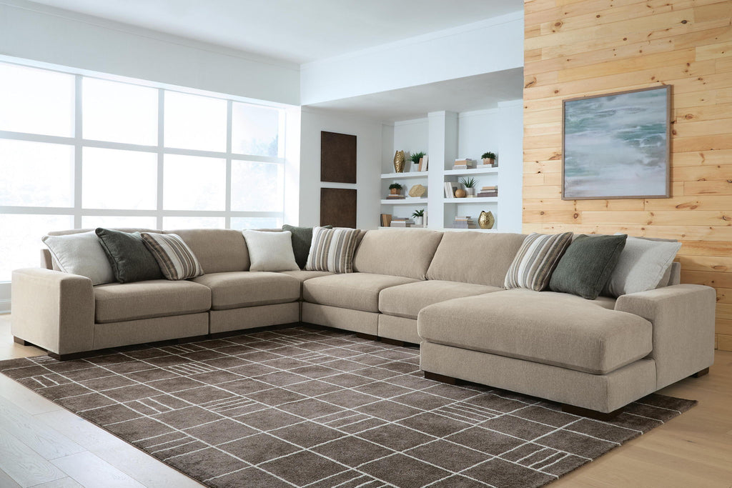 Light brown sectional sofa with chaise end and striped throw pillows