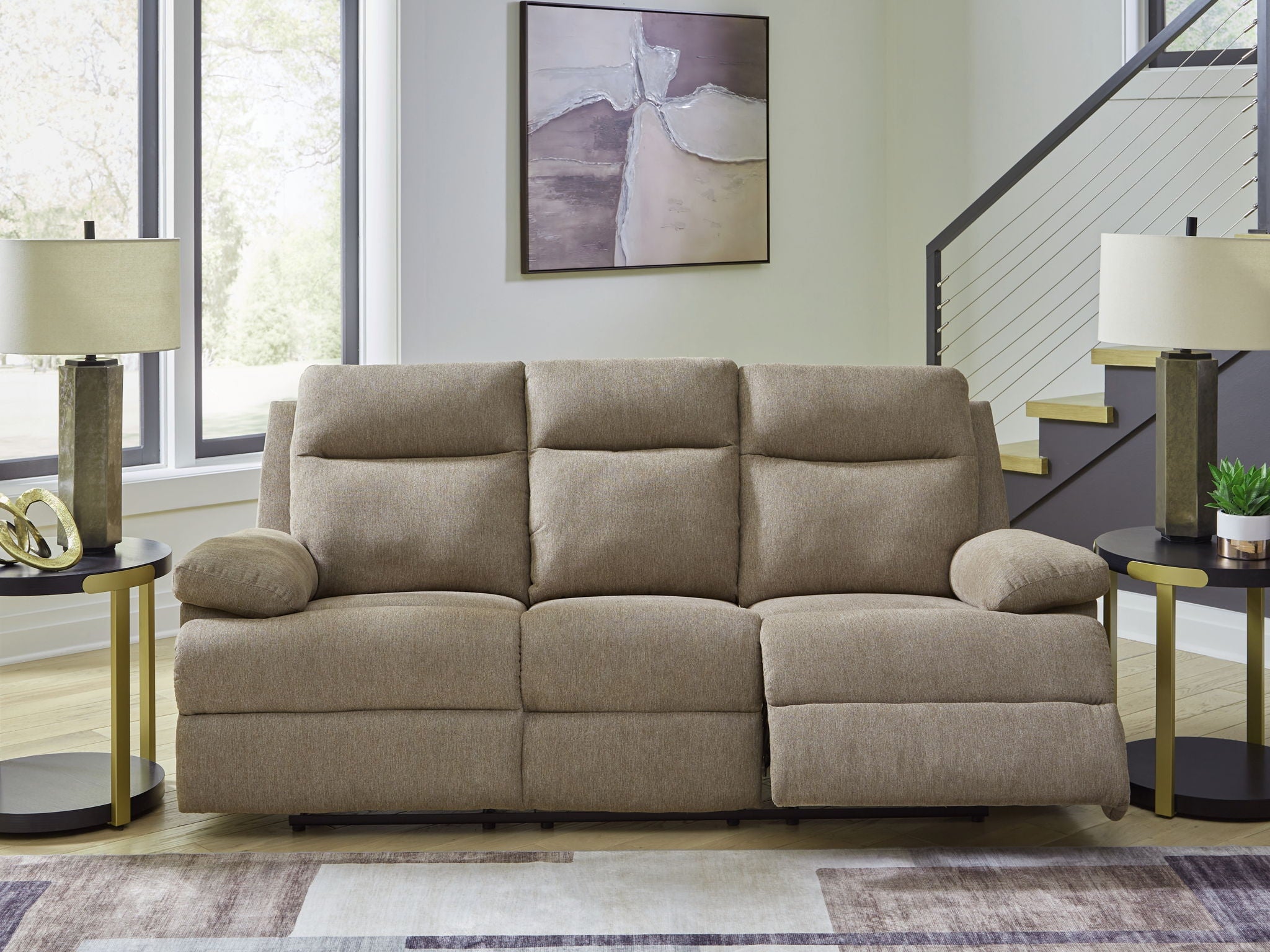 Beige reclining sofa with tufted back cushions and rounded armrests