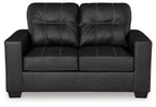 Black loveseat front view with tufted back and padded arms over a boxy seat