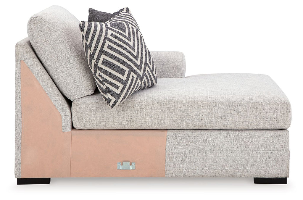 Stone corner chaise with wood side panel, tufted back, striped accent pillow.