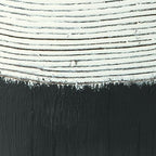 Close-up of vase midsection: white striped top over dark black textured base