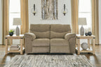 Taupe fabric sofa with rolled arms and three cushioned back panels