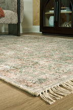 Rossbury rug corner detail, speckled multicolor texture with cream fringe tassels