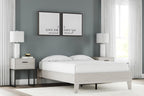 Platform bed with light wood frame and white mattress, raised platform with slat support