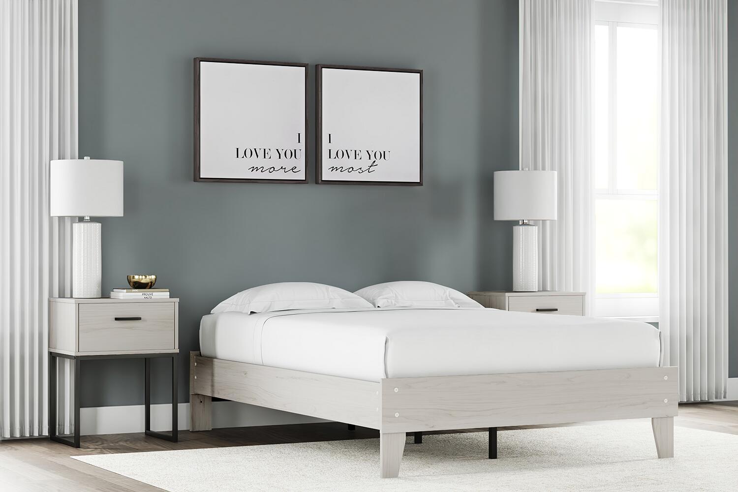 Platform bed with light wood frame and white mattress, raised platform with slat support