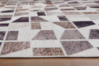 Jettner area rug surface with white geometric blocks and speckled gray and brown