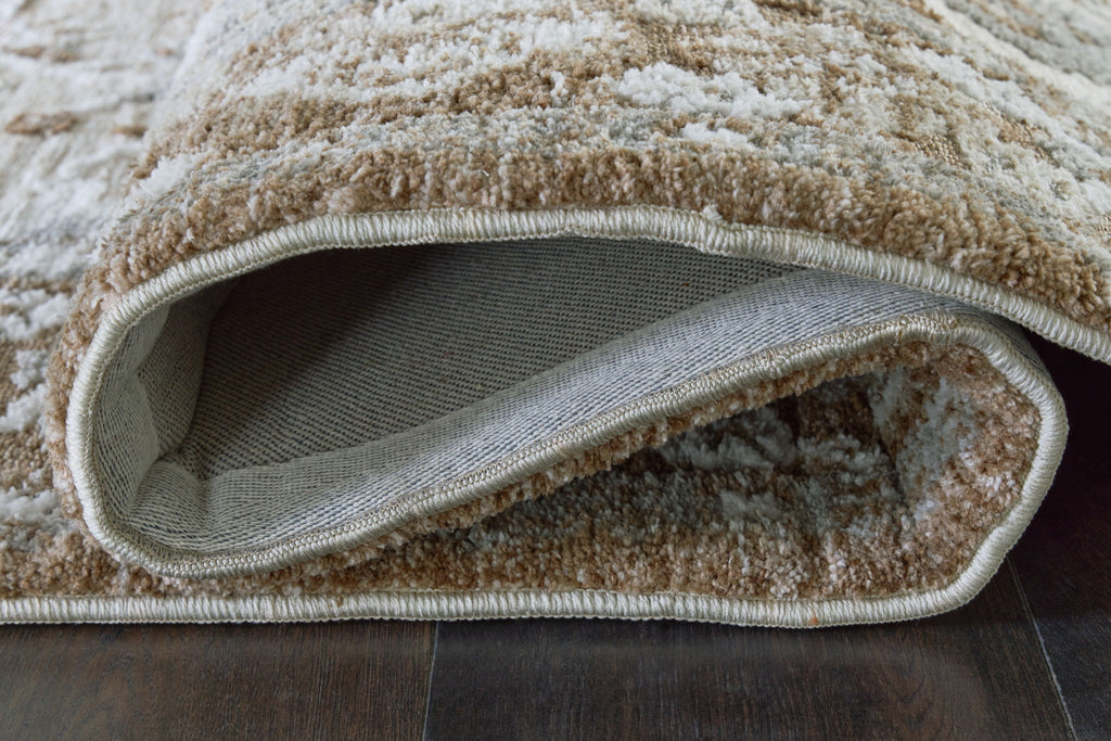 Memory foam rug edge showing stitched border and underside in gray