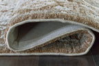 Memory foam rug edge showing stitched border and underside in gray