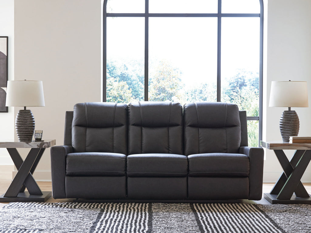 Black reclining sofa with tufted back cushions and wide segmented seat with armrests