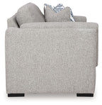 Light gray loveseat sofa with rounded arms and white-and-blue striped throw pillows